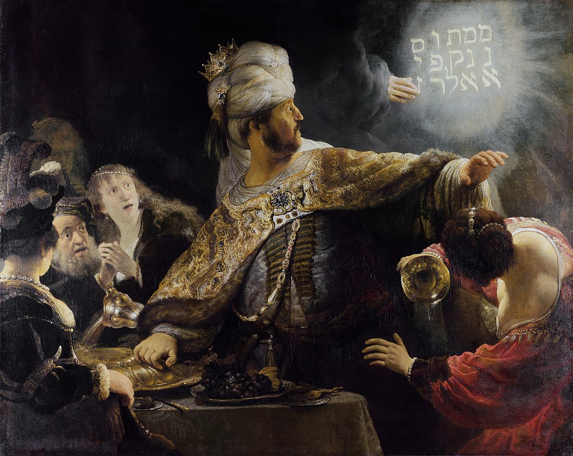 Rembrandt, Belshazzar's Feast, 1635, (National Gallery, London). The message is written in vertical lines starting at the top right corner, with "upharsin" taking two lines.